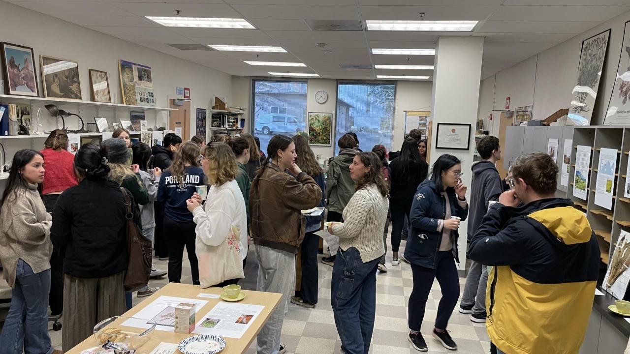 Large crowd gathered at 2024 Herbarium Tea admiring exhibits.
